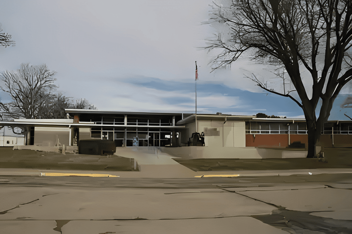 Mid-century school facade with overcast sky