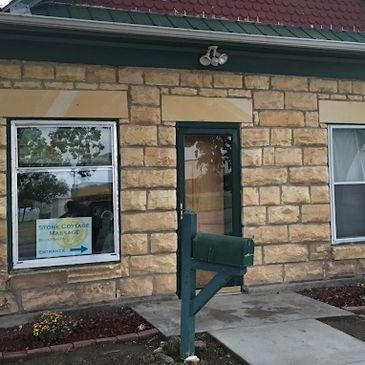 Rustic cottage exterior with window sign